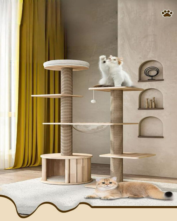 Modern beige cat tree tower with scratching posts, plush platforms, a hideaway, and a hanging toy ball in a stylish living room with yellow curtains and light wood flooring