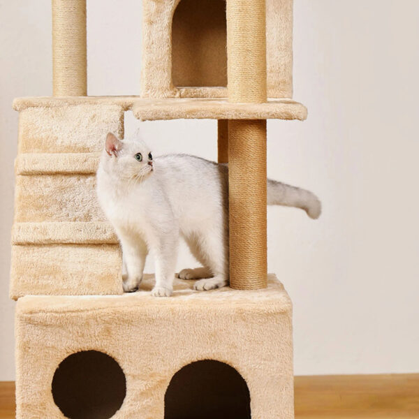 Beige multi-level cat tree with scratching posts, enclosed hideaways, dangling toys, and a stable base